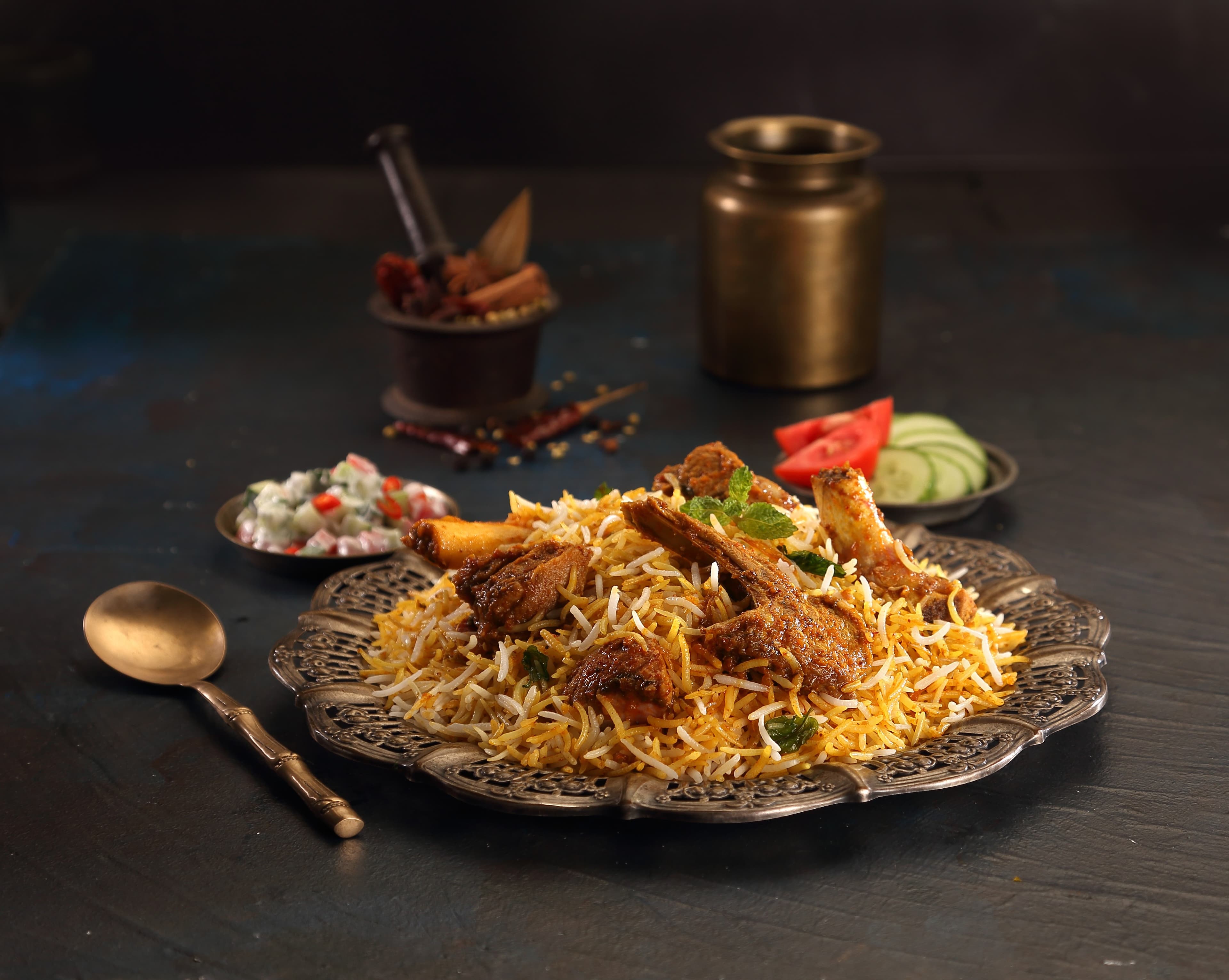 Mutton Biryani — slow-cooked tender mutton layered with aged basmati and ground house masala, crowned with birista